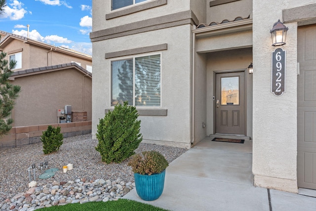 entrance to property with stucco siding