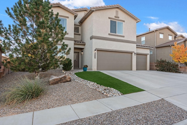 view of front of property featuring a garage, driveway, a tile roof, and stucco siding