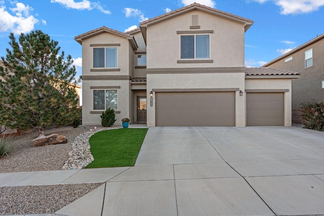 view of front of house with concrete driveway, a tiled roof, and stucco siding