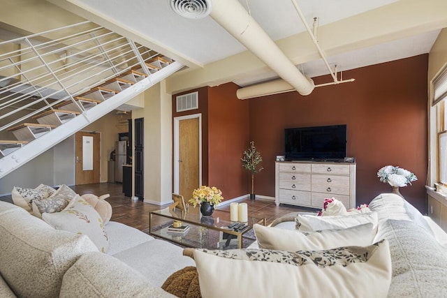 tiled living room featuring visible vents, stairway, and baseboards