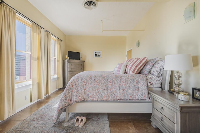 bedroom featuring visible vents and dark tile patterned floors