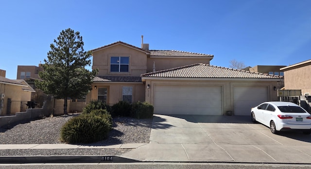 view of front of property featuring driveway, an attached garage, a tiled roof, and stucco siding