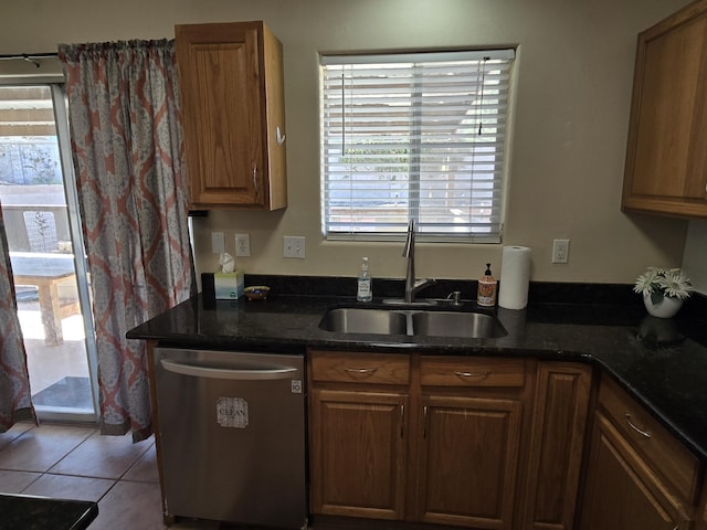 kitchen featuring plenty of natural light, dishwasher, a sink, and tile patterned floors