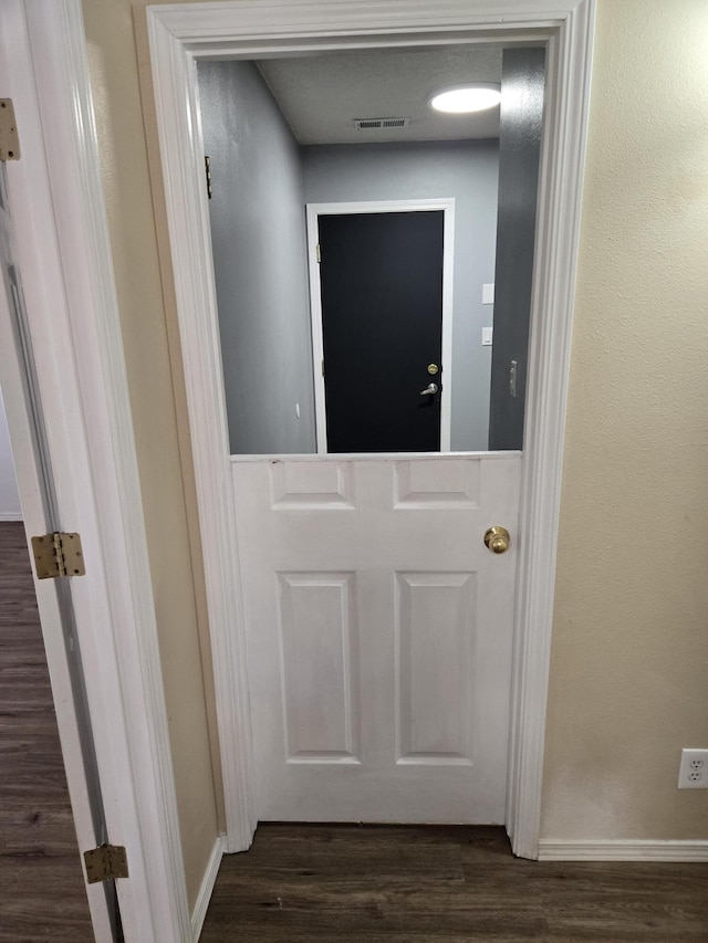 room details with visible vents, baseboards, and wood finished floors