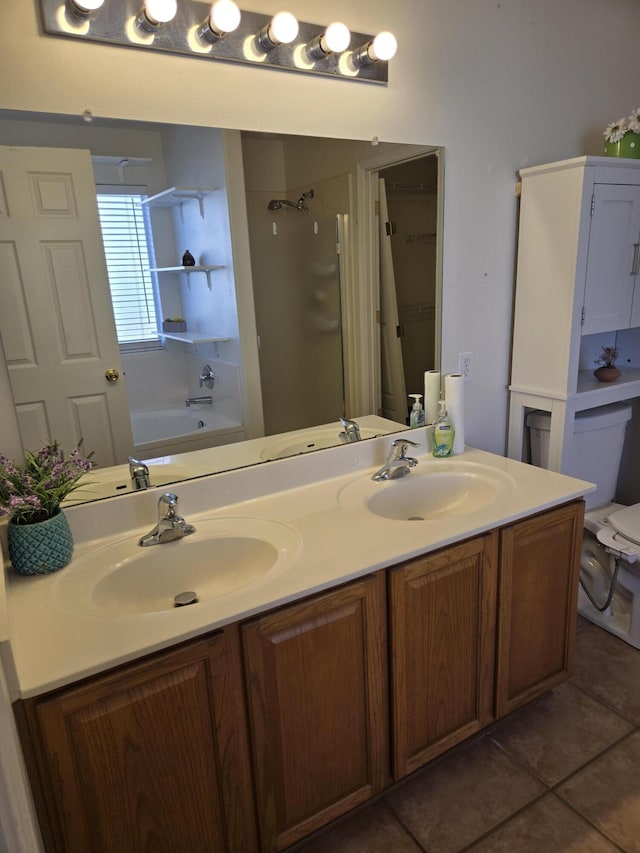 full bathroom with a shower, a sink, and double vanity