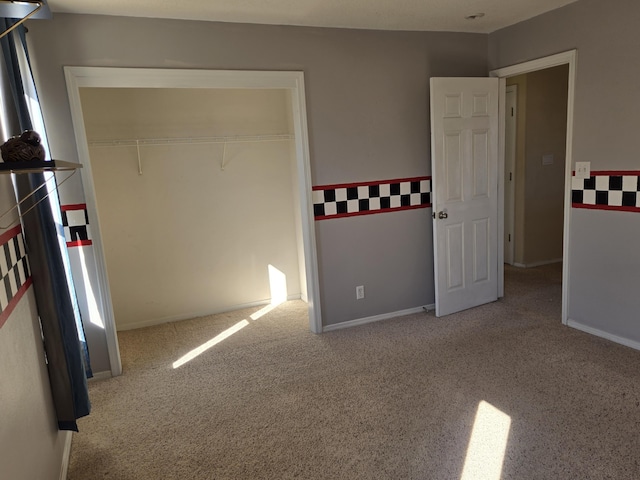 unfurnished bedroom with carpet and baseboards