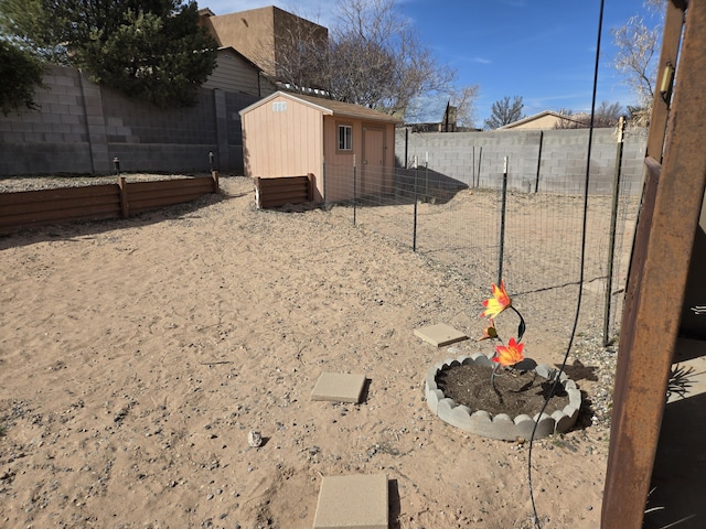 view of yard featuring an outbuilding and a fenced backyard