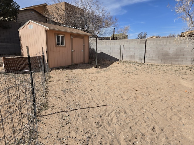 exterior space featuring a fenced backyard, an outbuilding, and a shed