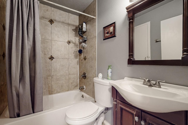 bathroom featuring toilet, shower / bath combo with shower curtain, and vanity