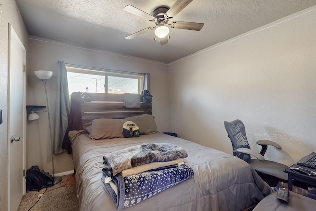 carpeted bedroom with a textured ceiling and ceiling fan