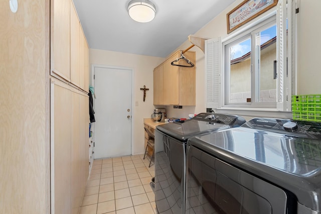 laundry area with cabinet space, washing machine and dryer, and light tile patterned flooring