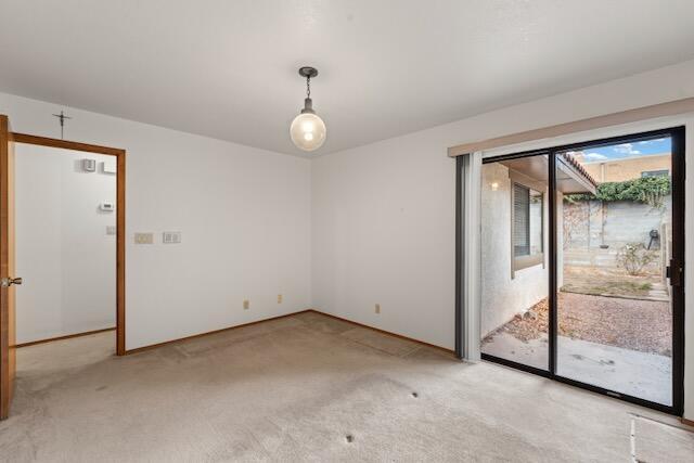 spare room featuring light colored carpet