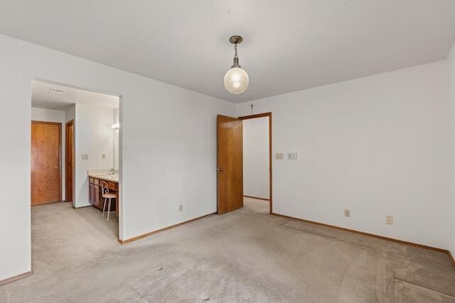 unfurnished bedroom with baseboards and light colored carpet