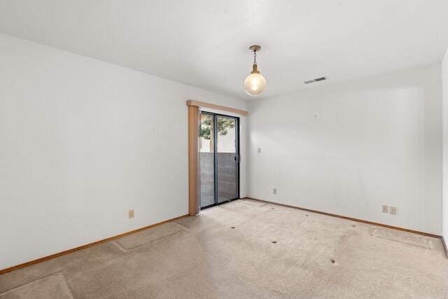 empty room with light carpet, visible vents, and baseboards