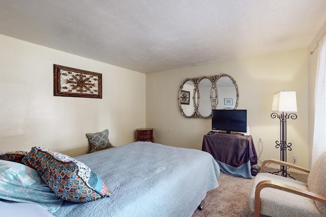 carpeted bedroom featuring a textured ceiling