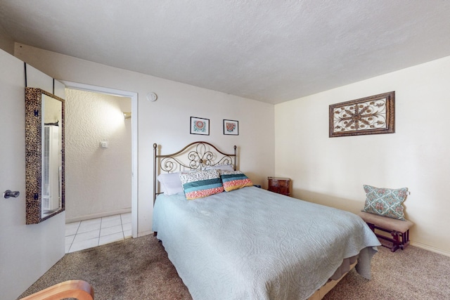 tiled bedroom featuring carpet and a textured ceiling