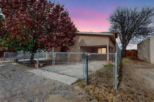 exterior space featuring fence private yard, a gate, and stucco siding