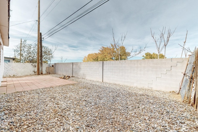 view of yard featuring a patio area and a fenced backyard