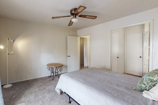 bedroom featuring ceiling fan and carpet