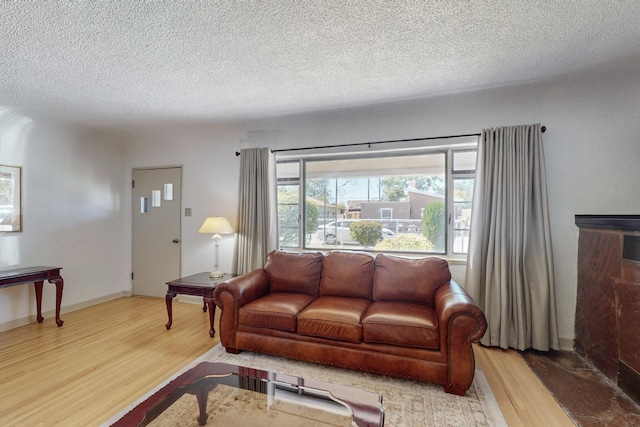 living room with a textured ceiling and wood finished floors