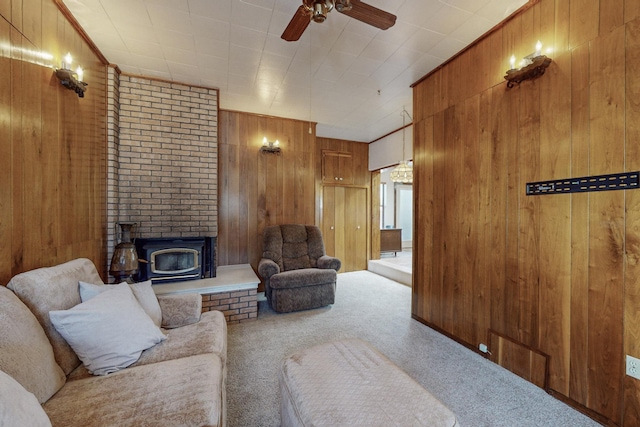 living room with carpet floors, wood walls, and ceiling fan