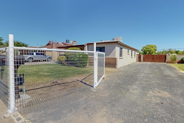 view of property exterior with a yard, fence, and stucco siding