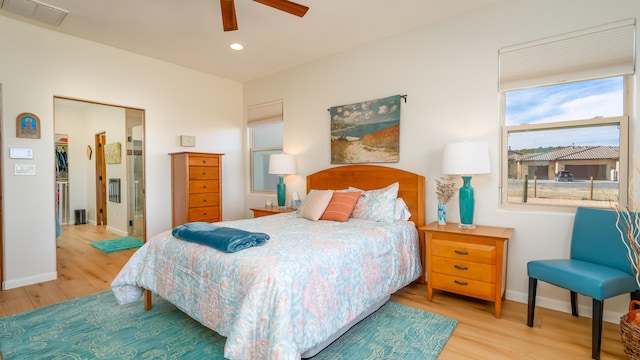 bedroom with recessed lighting, wood finished floors, visible vents, and baseboards