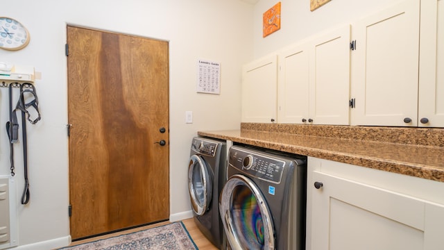 laundry room featuring cabinet space and separate washer and dryer