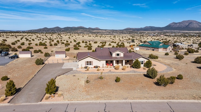 drone / aerial view featuring a mountain view and a desert view