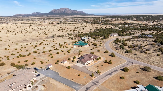 birds eye view of property featuring a mountain view and a desert view