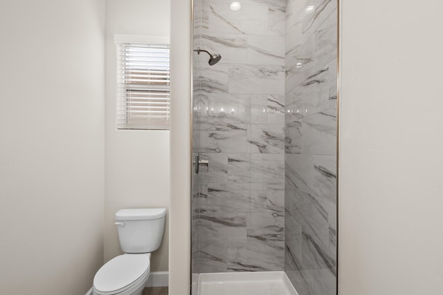 full bath featuring a shower stall, toilet, and baseboards