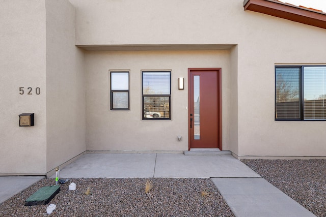 property entrance featuring a patio area and stucco siding