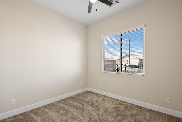 spare room featuring visible vents, carpet flooring, a ceiling fan, and baseboards