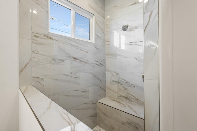 full bathroom with tiled shower