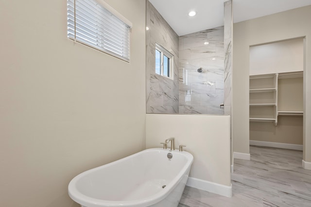 full bathroom featuring a marble finish shower, baseboards, marble finish floor, a freestanding tub, and recessed lighting