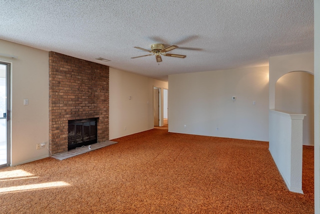 unfurnished living room featuring carpet, a fireplace, and visible vents