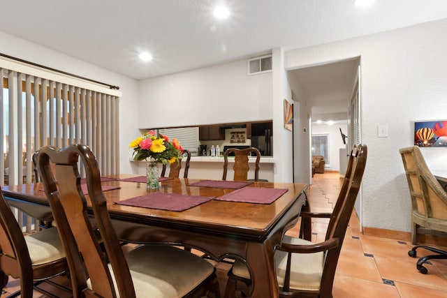 dining space with light tile patterned floors, visible vents, and recessed lighting