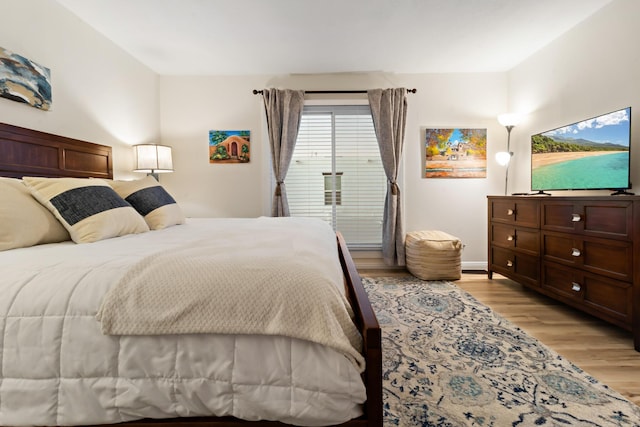 bedroom featuring light wood-style floors and baseboards