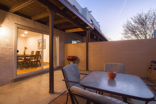 view of patio featuring outdoor dining area and fence