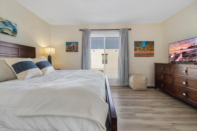 bedroom featuring light wood-style flooring and baseboards