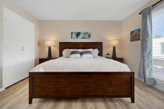 bedroom with a closet and light wood finished floors