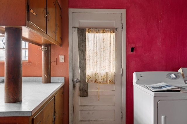 washroom with washer / dryer and cabinet space