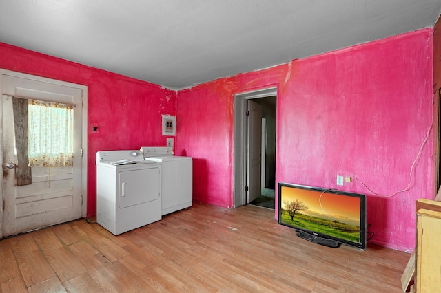 laundry area with washing machine and dryer, laundry area, electric panel, and wood finished floors