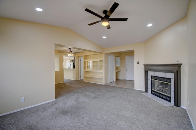 unfurnished living room with vaulted ceiling, carpet floors, a fireplace, and recessed lighting