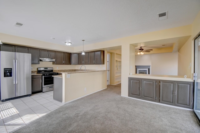 kitchen featuring light countertops, appliances with stainless steel finishes, visible vents, and light colored carpet