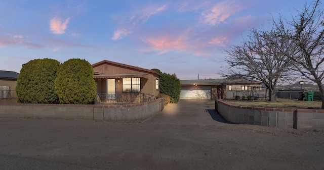 ranch-style house with a garage and fence