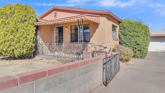 view of front of property featuring stucco siding and a porch