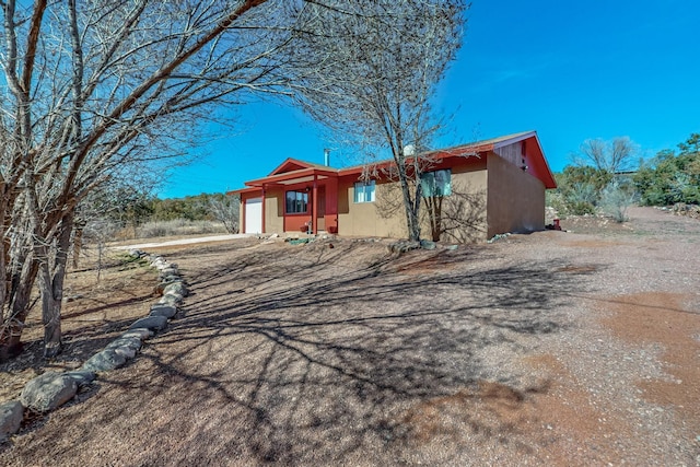 view of front of house with an attached garage and stucco siding