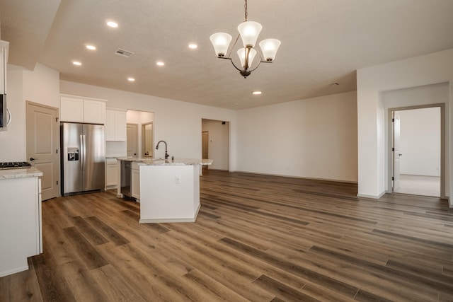 kitchen featuring visible vents, white cabinets, open floor plan, dark wood-style flooring, and stainless steel appliances