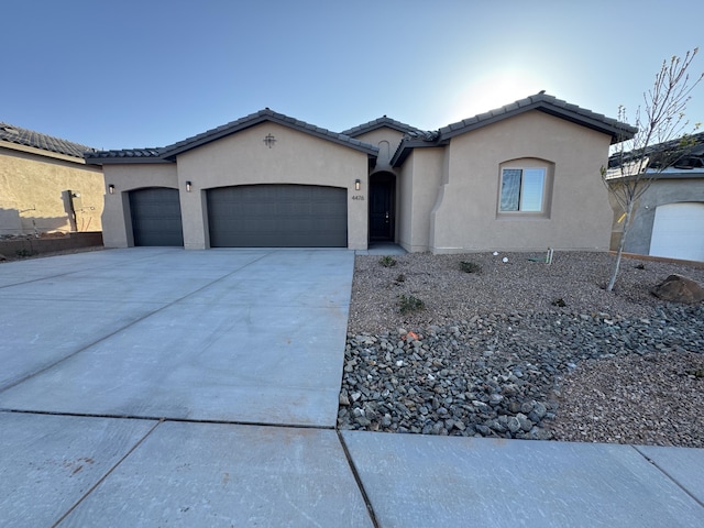 4476 George Loop, Rio Rancho, NM 87144 - ranch-style house with stucco siding, a tiled roof, driveway, and a garage